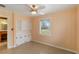 The bedroom features built-in cabinets and shelving, a window with blinds, and paneled walls at 217 Palm E Ave, Nokomis, FL 34275