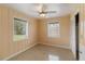 The bedroom boasts panelled walls, two windows with blinds, a ceiling fan, and a closet at 217 Palm E Ave, Nokomis, FL 34275