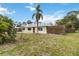 Charming home with a well-maintained front yard, complemented by mature landscaping and a private wooden fence at 217 Palm E Ave, Nokomis, FL 34275