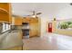 View from kitchen to living room with stainless appliances, wood cabinets, and adjacent dining area at 217 Palm E Ave, Nokomis, FL 34275