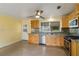 Compact kitchen offering stainless steel appliances, wooden cabinetry, and convenient access to back door at 217 Palm E Ave, Nokomis, FL 34275