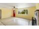 Sunny living room featuring an over-sized window, red door, and polished terrazzo flooring at 217 Palm E Ave, Nokomis, FL 34275
