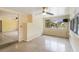 Spacious living area with ceiling fan, adjacent sitting area, and large windows at 217 Palm E Ave, Nokomis, FL 34275