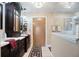 Bathroom featuring dark cabinetry, decorative lighting and a glass-enclosed shower at 2304 Bonn Ct, Punta Gorda, FL 33983
