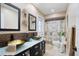 Modern bathroom featuring double vessel sinks, mosaic tile, and a separate toilet area at 2304 Bonn Ct, Punta Gorda, FL 33983
