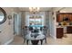 Dining area with view of the pool, elegant chandelier, and seamless flow into the kitchen at 2304 Bonn Ct, Punta Gorda, FL 33983