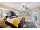 Main bedroom with ornate furniture and a door opening to the outdoor pool area at 2304 Bonn Ct, Punta Gorda, FL 33983