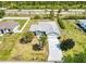Aerial view of a single-story home with a large driveway at 23482 Moreland Ave, Port Charlotte, FL 33954