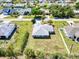 Aerial view of a single-story home surrounded by lush greenery in a residential area at 23482 Moreland Ave, Port Charlotte, FL 33954