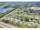 Aerial view of a residential area with single-Gathering homes near a lake and a highway at 23482 Moreland Ave, Port Charlotte, FL 33954