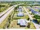 Aerial view showcasing the home's location near a highway and a lake at 23482 Moreland Ave, Port Charlotte, FL 33954