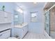 Cozy bathroom featuring a vanity, commode, and shower with glass doors at 23482 Moreland Ave, Port Charlotte, FL 33954