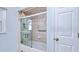 Bathroom featuring a shower with glass doors and a grab bar at 23482 Moreland Ave, Port Charlotte, FL 33954