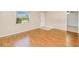 Cozy bedroom featuring hardwood flooring, neutral walls, and a window that allows natural light at 23482 Moreland Ave, Port Charlotte, FL 33954