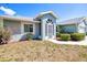 Well-maintained single-story home with tidy landscaping, a two-car garage, and a cozy front entrance at 23482 Moreland Ave, Port Charlotte, FL 33954