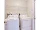 Small laundry room featuring a washer and dryer and overhead storage at 23482 Moreland Ave, Port Charlotte, FL 33954