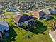Aerial view of a home featuring a screened-in lanai and lush landscaping at 2363 Jasmine Way, North Port, FL 34287