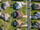 Aerial view of a well-maintained home with a screened-in patio and manicured landscaping in a sunny neighborhood at 2363 Jasmine Way, North Port, FL 34287