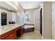 Bright bathroom with a double vanity, a soaking tub, and decorative chandelier at 2363 Jasmine Way, North Port, FL 34287