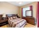 Bedroom featuring wood flooring and large dresser at 2363 Jasmine Way, North Port, FL 34287