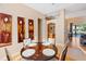 Dining room featuring elegant artwork and a view into the living area and sliding glass doors at 2363 Jasmine Way, North Port, FL 34287