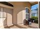 A charming screened-in entryway with tile flooring and comfortable seating for guests at 2363 Jasmine Way, North Port, FL 34287