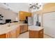Bright kitchen with stainless steel appliances, pantry, ample counter space, and views to the living room at 2363 Jasmine Way, North Port, FL 34287
