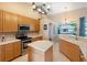 Well-lit kitchen with stainless steel appliances and a central island at 2363 Jasmine Way, North Port, FL 34287