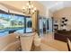 Bright and open living area with a built-in bar, pool views, and access to a screened in patio at 2363 Jasmine Way, North Port, FL 34287