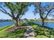 Scenic view of a pond with a gazebo, trees, and walking path at 2363 Jasmine Way, North Port, FL 34287