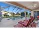 Refreshing screened-in pool, complemented by cozy lounge chairs, perfect for leisure at 2363 Jasmine Way, North Port, FL 34287