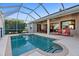 Sparkling pool surrounded by an expansive patio and seating, creating an ideal outdoor oasis at 2363 Jasmine Way, North Port, FL 34287