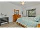 Light-filled bedroom with a ceiling fan and sliding glass door to lanai at 24648 Buckingham Way, Port Charlotte, FL 33980