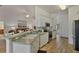 Open kitchen with white cabinets and stainless steel appliances at 24648 Buckingham Way, Port Charlotte, FL 33980