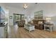 Inviting living room features hardwood floors, leather sofa, and sliding glass doors to the outside at 24648 Buckingham Way, Port Charlotte, FL 33980