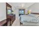 Spacious main bedroom with an en suite bathroom and sliding glass door to screened outdoor seating at 24909 Drumblaire Ct, Port Charlotte, FL 33980