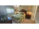 Cozy bedroom with tropical bedding, side tables with lamps, and natural light from the window at 25275 Rampart Blvd # 206, Punta Gorda, FL 33983