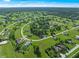 Expansive aerial view of a residential area with mature trees, green lawns and single-Gathering homes at 25428 Islas Dr, Punta Gorda, FL 33955