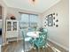 Cozy dining area featuring a window with natural light, a modern cabinet, and table with blue chairs at 25428 Islas Dr, Punta Gorda, FL 33955