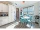 Charming breakfast nook with bright window, turquoise chairs, and modern cabinetry at 25428 Islas Dr, Punta Gorda, FL 33955