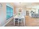 Bright dining area featuring white furniture, a stylish chandelier, and a large window with blinds at 25428 Islas Dr, Punta Gorda, FL 33955