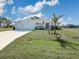 Charming single-story home with a well-manicured lawn, three-car garage, and beautiful landscaping at 25428 Islas Dr, Punta Gorda, FL 33955
