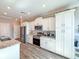 Modern kitchen with white cabinets, stainless steel appliances, and stylish countertops at 25428 Islas Dr, Punta Gorda, FL 33955