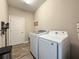 Laundry room with washer, dryer, utility sink, and tiled floors at 25428 Islas Dr, Punta Gorda, FL 33955