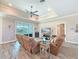 Comfortable living room with tile floors, recessed lighting, and a sliding door to the backyard at 25428 Islas Dr, Punta Gorda, FL 33955