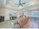 Bright and airy living room with tile floors, tray ceilings, and an open layout at 25428 Islas Dr, Punta Gorda, FL 33955