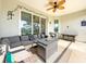 Screened in patio featuring wicker furniture, ceiling fan, and backyard view at 25428 Islas Dr, Punta Gorda, FL 33955