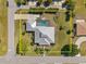 Top-down aerial view of a single-Gathering home with a screened in pool and meticulously maintained landscaping at 303 W Grace St, Punta Gorda, FL 33950