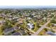 Aerial view of the home with pool and lake access surrounded by lush landscape at 303 W Grace St, Punta Gorda, FL 33950