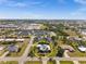 Aerial view of a single-Gathering home with a pool surrounded by lush greenery in a residential neighborhood at 303 W Grace St, Punta Gorda, FL 33950